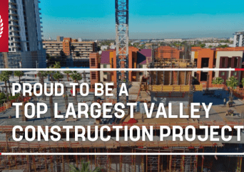 A construction site with scaffolding and cranes is shown in an urban area, with the text Proud to be a top largest valley construction project written across the image.
