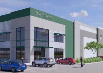 A modern, two-story commercial building with large windows and a sign reading TENANT SIGNAGE. Several cars are parked in front, and a few people are walking near the entrance on a sunny day.