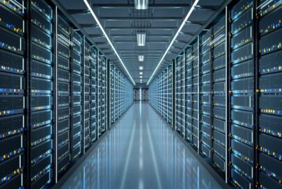 A data center with rows of server racks on both sides, illuminated by overhead fluorescent lights, creating a symmetrical and high-tech atmosphere. The servers are filled with blinking indicator lights.